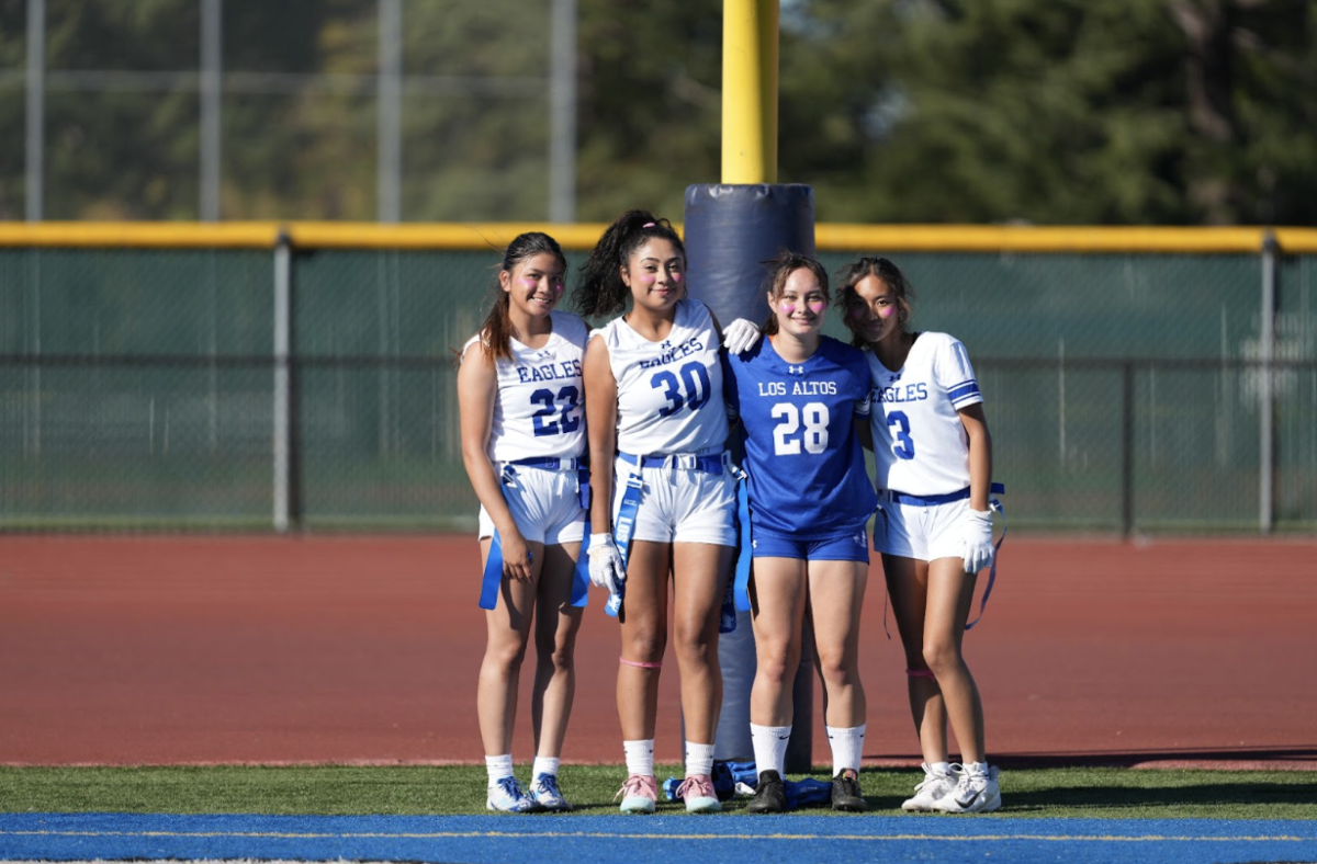 Girls flag football seniors pose before the game begins